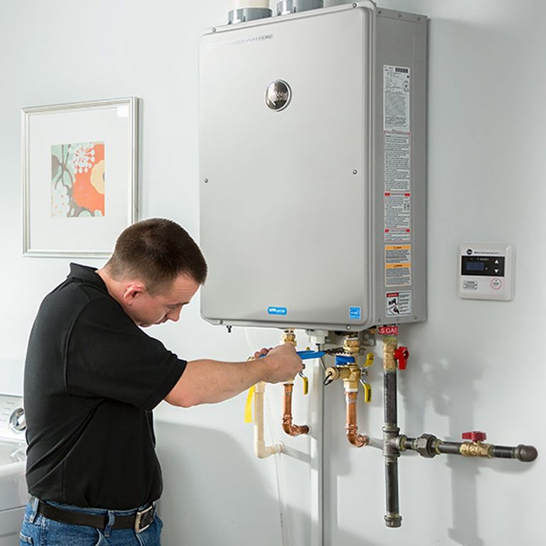 Technician servicing tankless water heater Vancouver